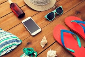 close up of smartphone and beach stuff